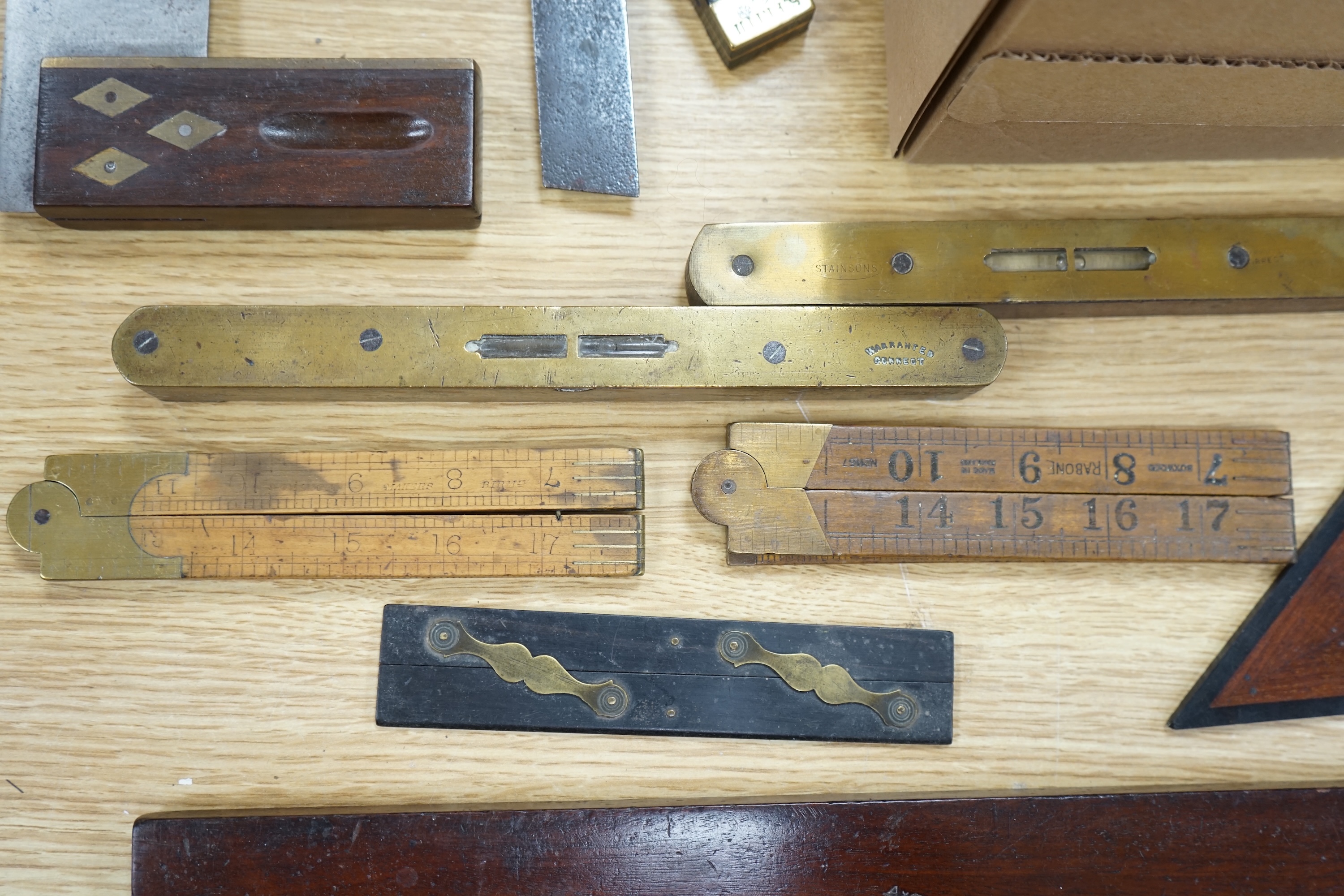 A collection of 19th and 20th century drawing instruments, including; levels, rulers, a set square etc. longest 79cm. Condition - variable, mostly fair to good